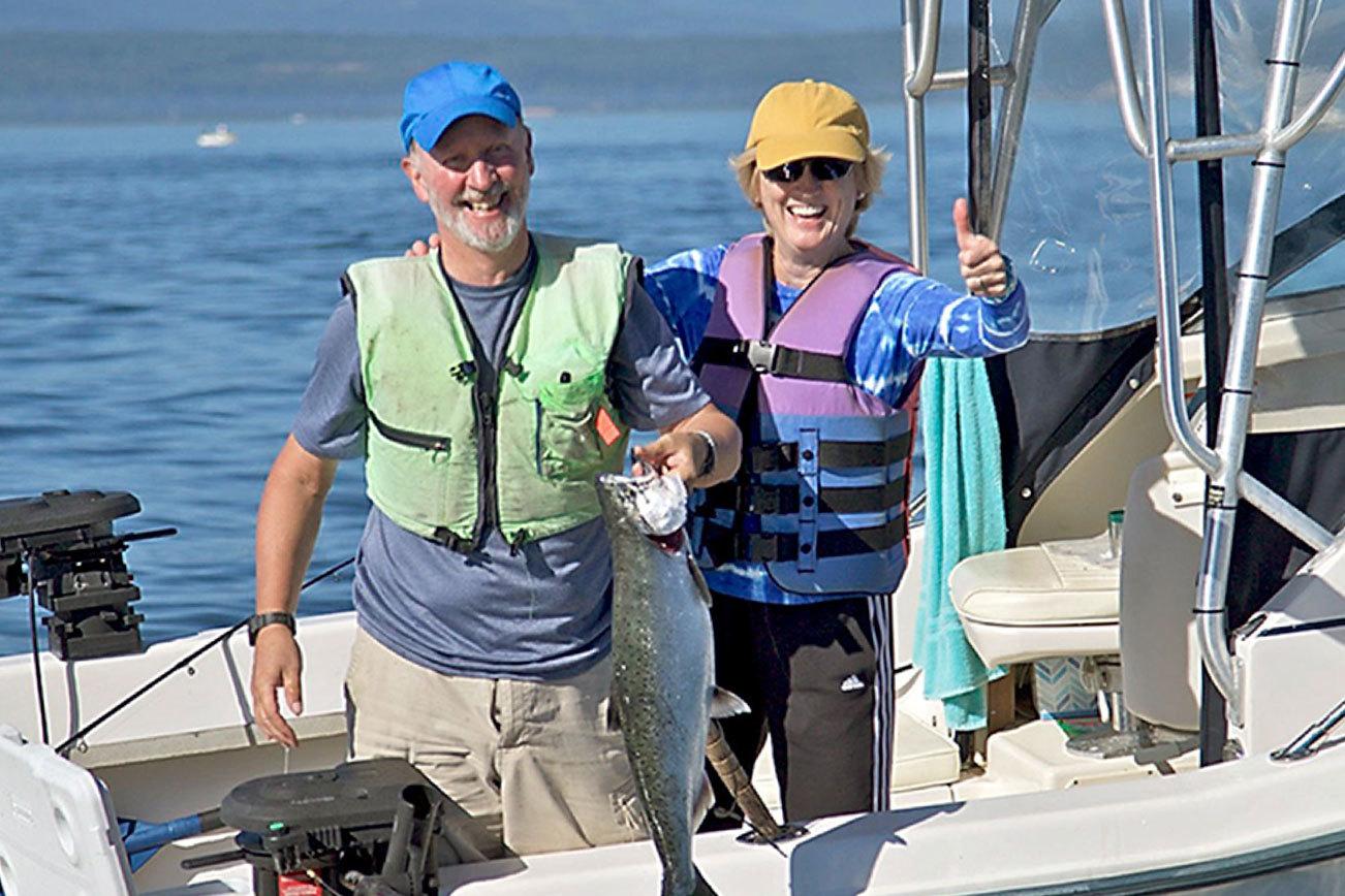 Steve Mullensky/for Peninsula Daily News                                John Reed and Karen Overstreet, both fof Seattle, show off a chinook caught while fishing atMidchannel Bank off Port Townsend.