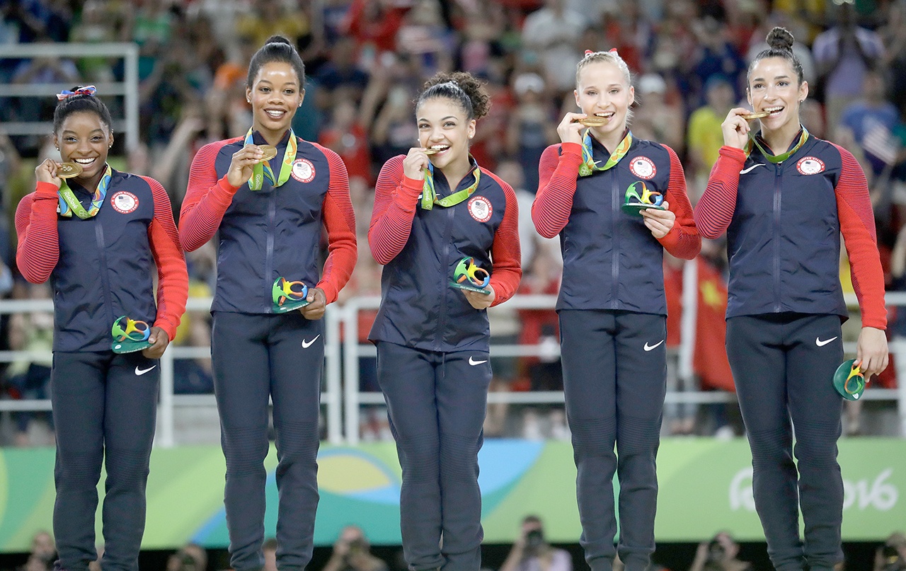 The Associated Press                                U.S. gymnasts, left to right, Simone Biles, Gabrielle Douglas, Lauren Hernandez, Madison Kocian and Aly Raisman hold their gold medals during the medal ceremony for the artistic gymnastics women’s team at the 2016 Summer Olympics in Rio de Janeiro, Brazil, Tuesday, Aug. 9, 2016.