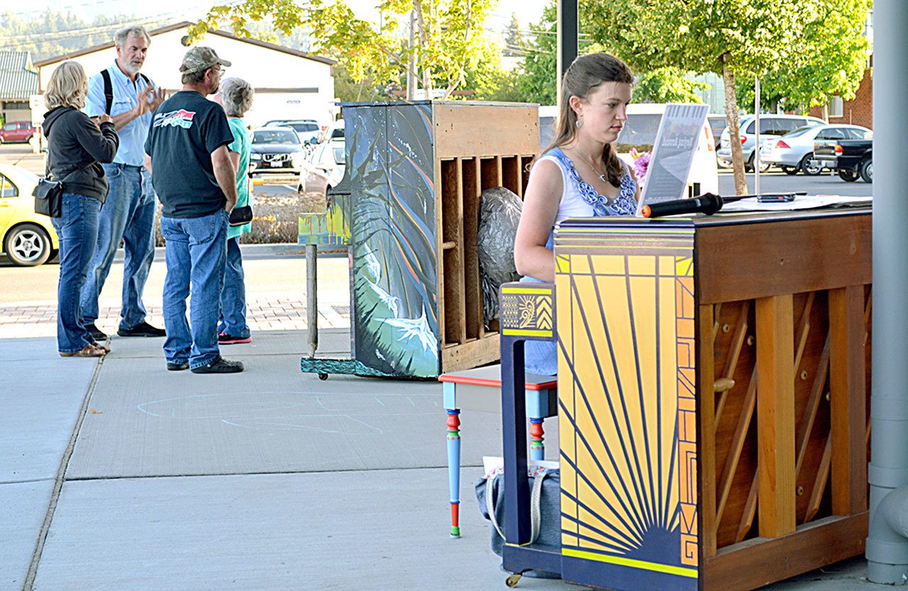 Joy Wetterlund of Port Angeles plays one of the Keying Around pianos last Friday. Wetterlund said she played one of the pianos at Over the Fence while it was on display and she wanted to come back and play. (Matthew Nash/Olympic Peninsula News Group)