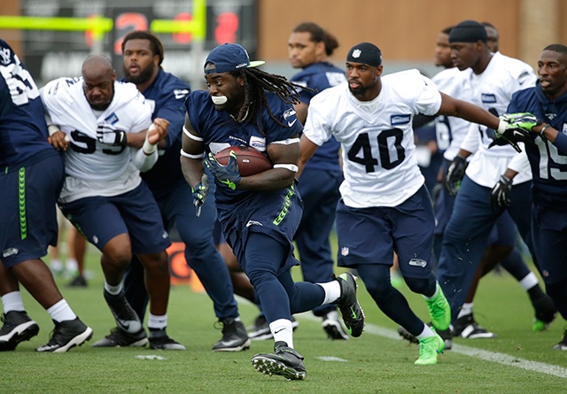 The Associated Press                                Seattle Seahawks running back Alex Collins, center left, carries the ball during NFL football training camp, Saturday, Aug. 6, 2016, in Renton.