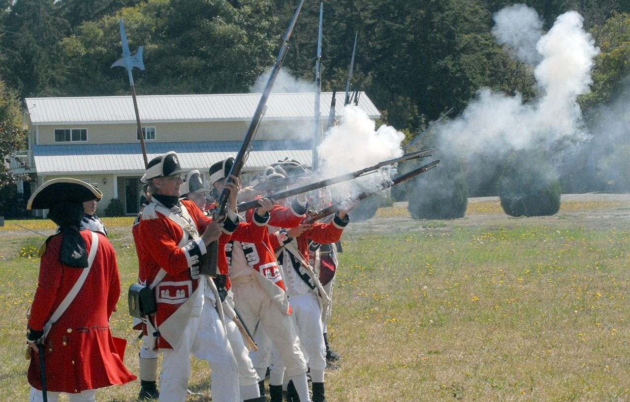 Reenactors dressed as British redcoats fire upon American militiamen during a recreation of the Battle of Lexington Green during Saturday’s Northwest Colonial Festival at the George Washington Inn near Agnew. (Keith Thorpe/Peninsula Daily News)