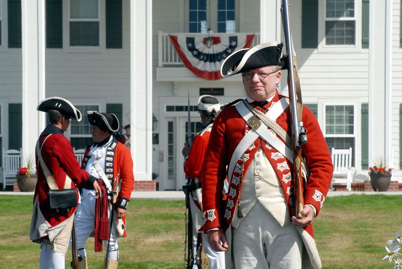 British redcoat reenactor John Hess of Fairplay, Calif., stands guard at the gate to the George Washington Inn, the site of the Northwest Colonial Festival. (Keith Thorpe/Peninsula Daily News)