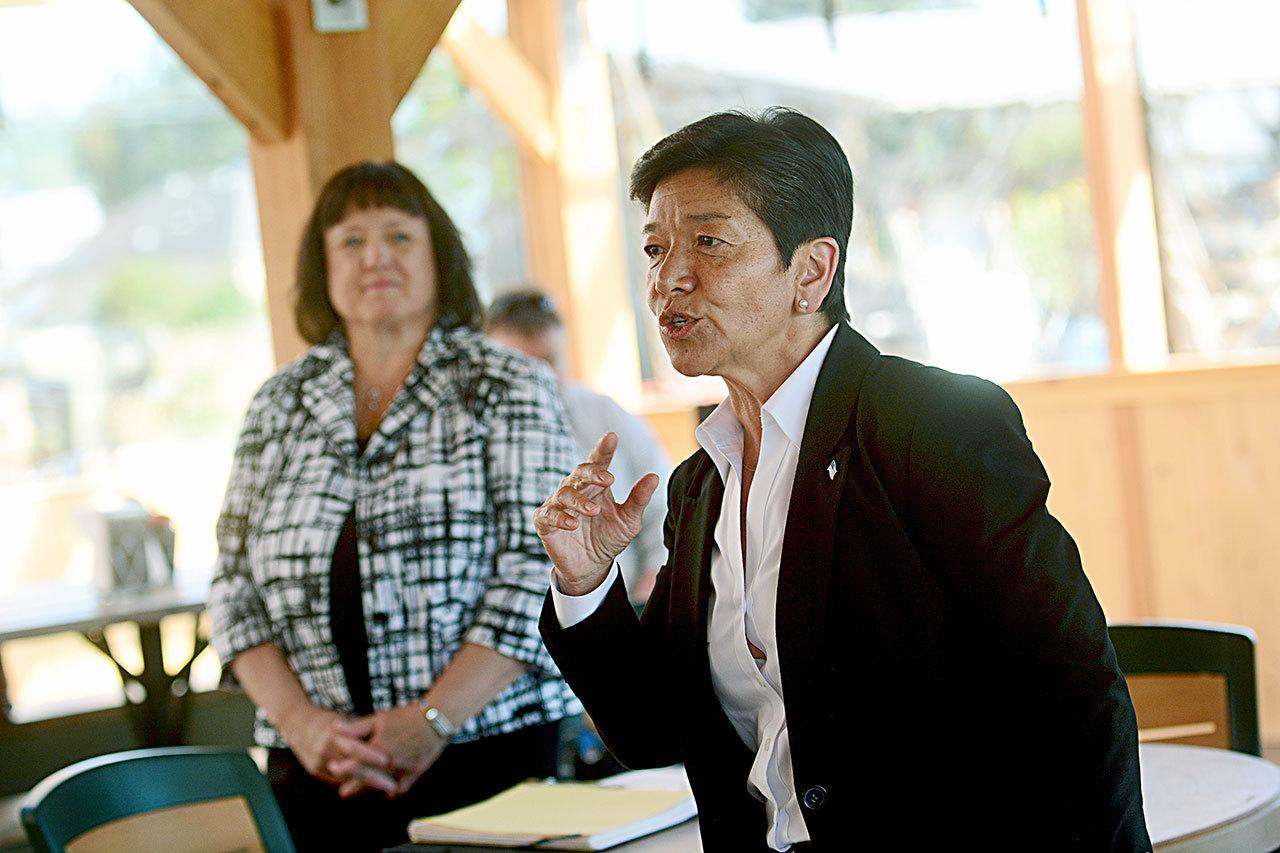 The state Supreme Court’s most junior Justice, Mary Yu, foreground, and Chief Justice Barbara Madsen, during an event in Chimacum on Friday, said there is a coordinated effort to unseat the three justices running for re-election over two controversial school-funding rulings. (Jesse Major/Peninsula Daily News)