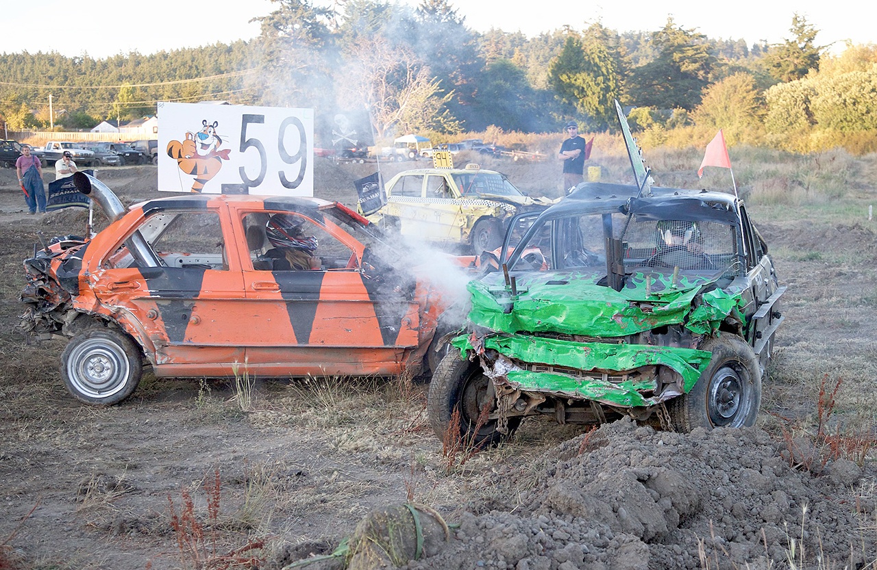 Steve Mullensky/for Peninsula Daily News Auburn&rsquo;s Kylee Timlick, driving the No. 59 car, delivers the final blow to a car driven by Port Orchard&rsquo;s Zach Bretcher in the kids demolition derby during the Jefferson County Fair on Saturday in Port Townsend. Timlick took home the $1,000 first prize Bretcher picked up $500 for his efforts.
