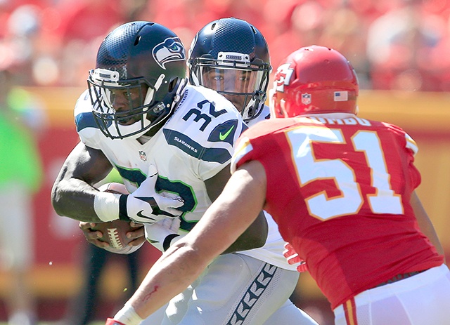 The Associated Press                                Seattle&rsquo;s Christine Michael (32) runs between his quarterback Trevone Boykin, rear, and Kansas City Chiefs linebacker Frank Zombo during the Seahawks preseason victory.