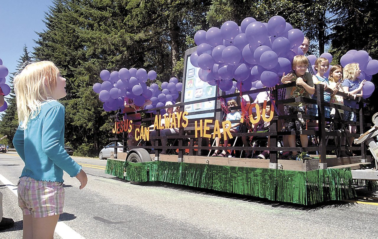 Darica Bertelson, 5, of Joyce shows elation as a float created by Joyce Bible Church passes by during the 33rd annual Joyce Daze and Wild Blackberry Festival grand parade last year. The festival also featured food, crafts, entertainment and, of course, blackberry pie. (Keith Thorpe/Peninsula Daily News)