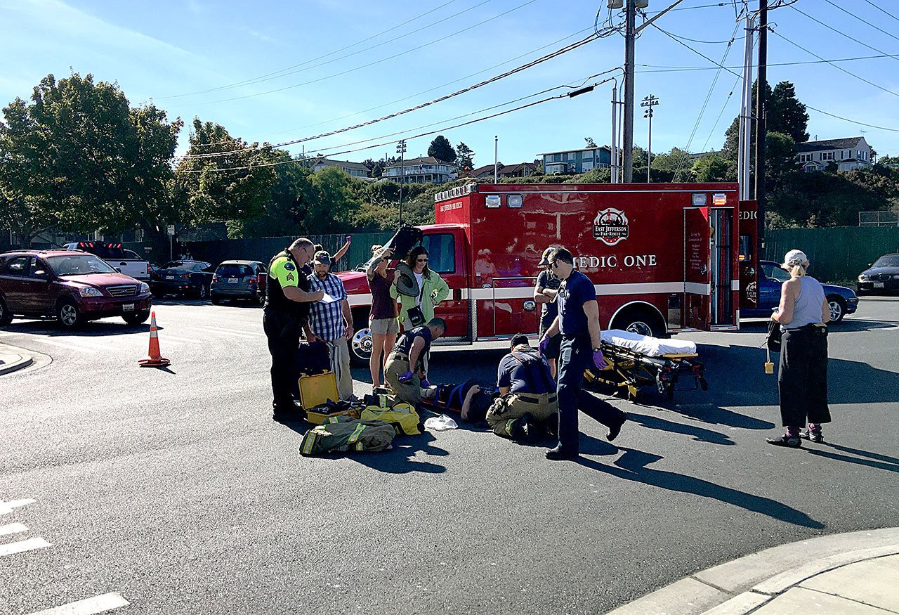 Emergency personnel prepare to take a 76-year old Port Townsend man to Jefferson Healthcare after his bicycle collided with a pickup truck. (Bill Beezley/East Jefferson Fire-Rescue)