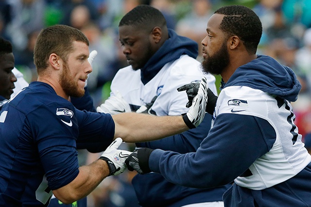 The Associated Press Seattle Seahawks defensive end Michael Bennett, right, blocks tight end Clayton Echard during a training camp practice earlier this month.