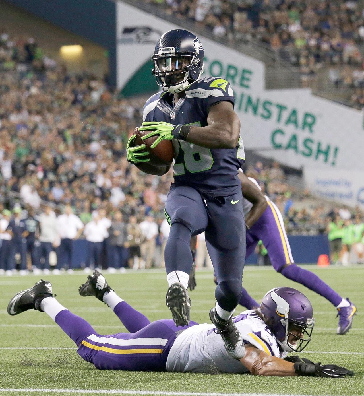 The Associated Press Seattle Seahawks running back Troymaine Pope scores a touchdown after avoiding a tackle from Minnesota Vikings defensive end Justin Trattou during last week’s preseason game.