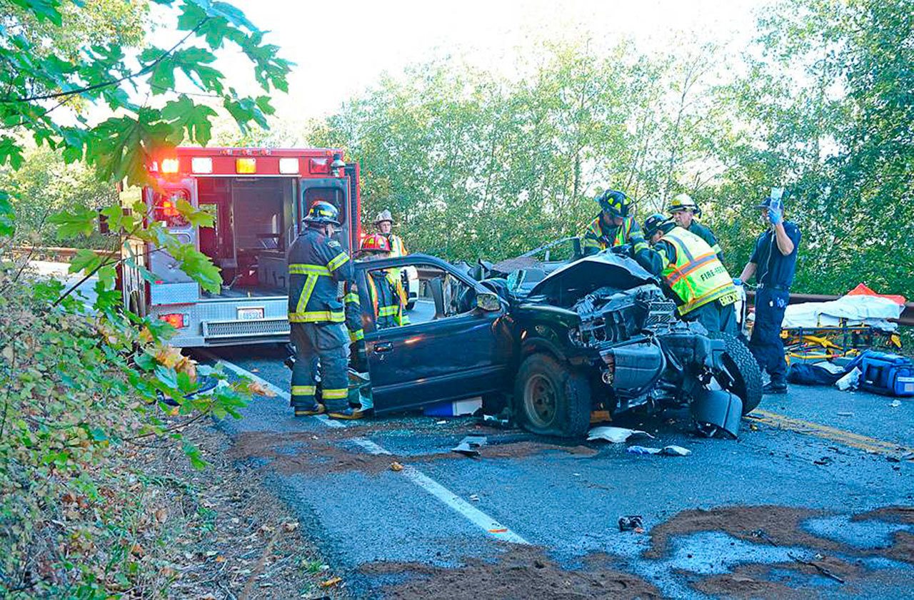 Firefighters assist at the scene of a head-on collision on U.S. Highway 101 west of Port Angeles on Saturday. (Jay Cline/Clallam County Fire District No. 2)
