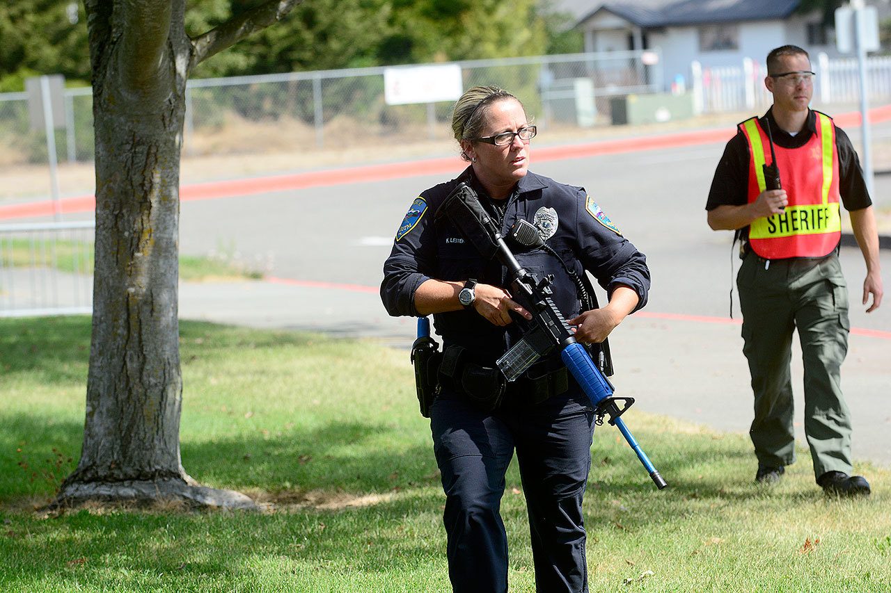 Officers respond to a mass casualty shooting drill at Greywolf Elementary School on Friday. (Jesse Major/Peninsula Daily News)