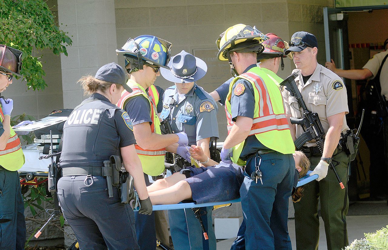 Paramedics and officers respond to a mass shooting drill at Greywolf Elementary School in Carlsborg on Friday. (Jesse Major/Peninsula Daily News)