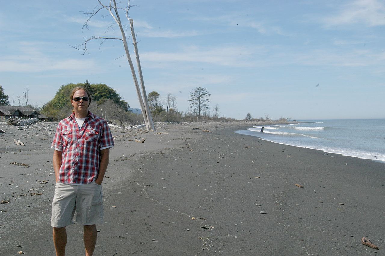 Jamie Michel, nearshore biologist with the Coastal Watershed Institute, stands on a newly formed beach east of the Elwha River Mouth on Friday. (Rob Ollikainen/Peninsula Daily News)
