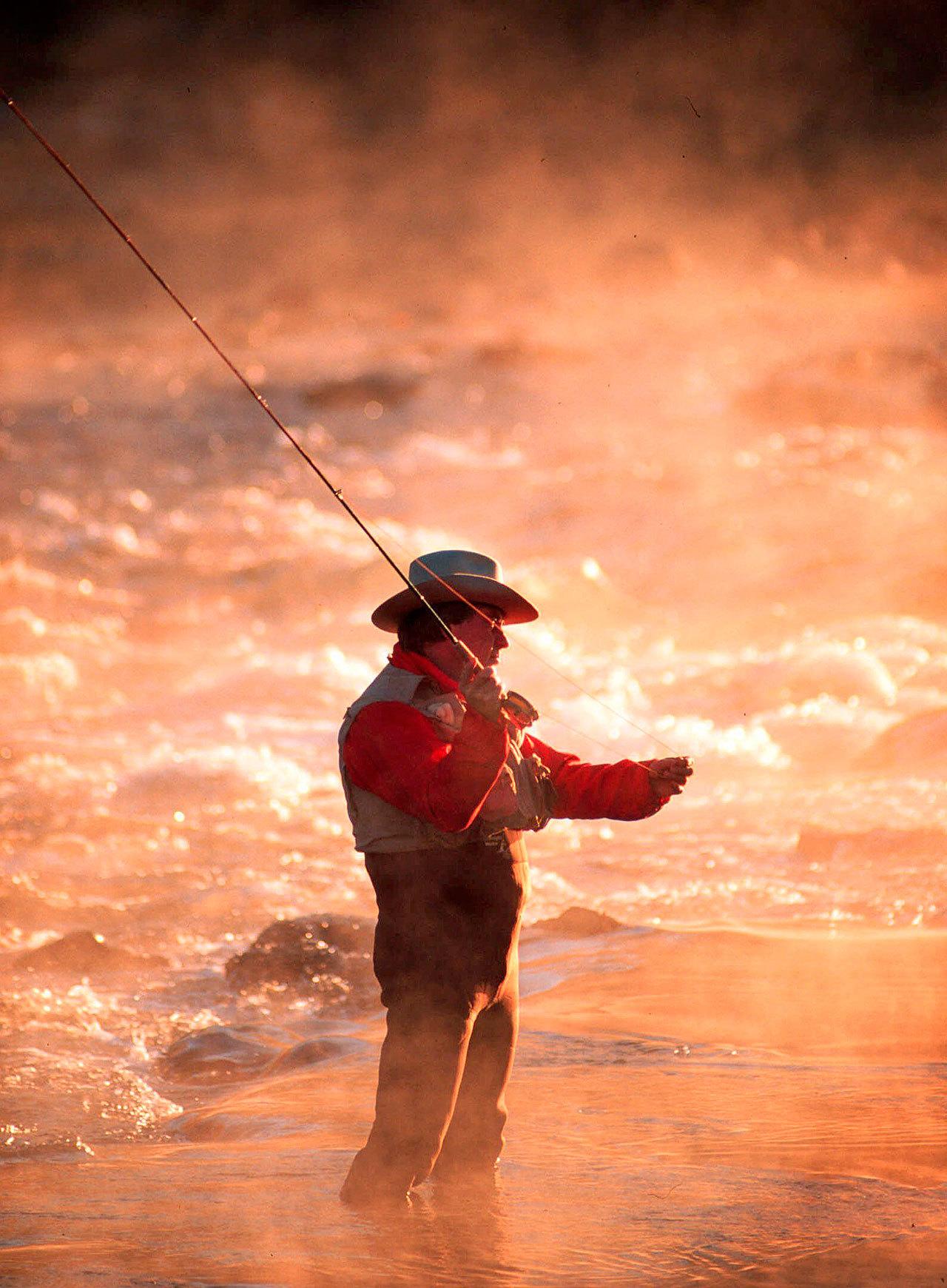 A fly-fisherman casts his line as early morning mist rises above the Boise River, east of Boise, Idaho. Idaho, Oregon and Washington have shut down online sales of hunting and fishing licenses amid concerns a vendor’s computer system has been hacked and personal information is at risk. (Troy Maben/The Associated Press)