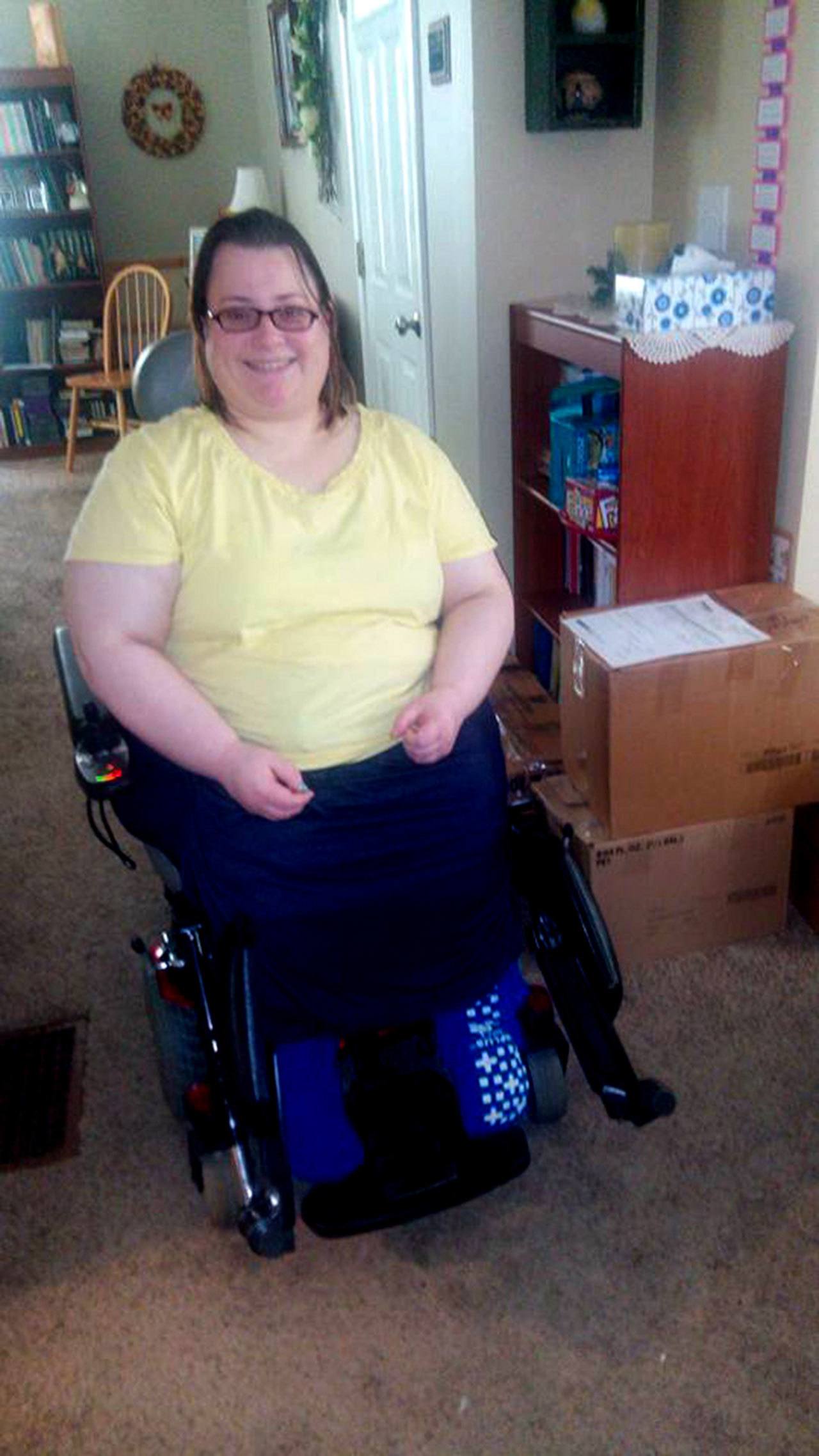 Rebecca Stebler — 31, of Shelby, Ohio — was born with spina bifida. She is seen here in her home in her new wheelchair. (Gail Allyson King)