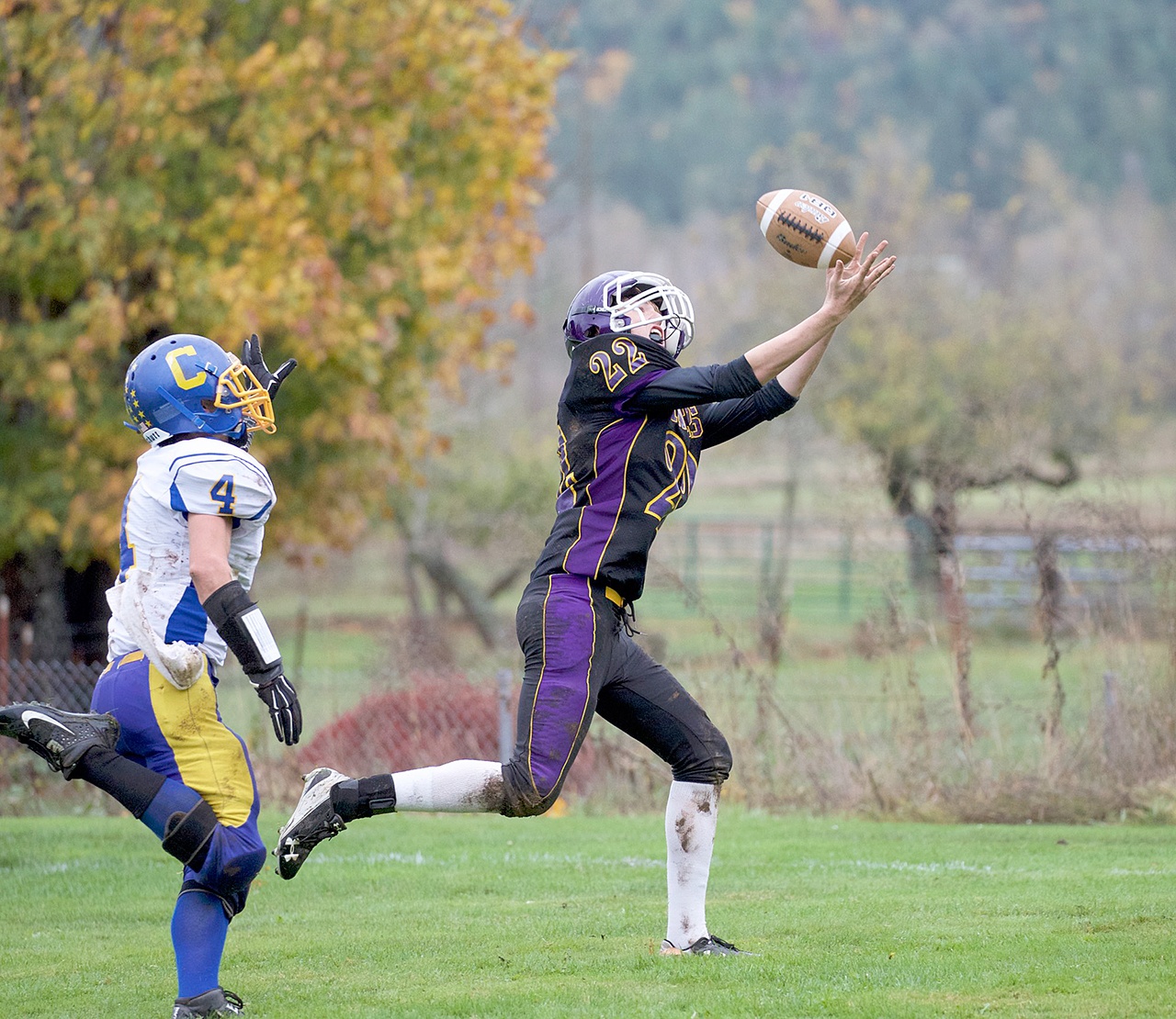 Steve Mullensky/for Peninsula Daily News Quilcene’s Jarod Smith, right, beats out Crescent’s Eric Emery and hauls in a 30-yard touchdown pass during a game played in Quilcene last fall.