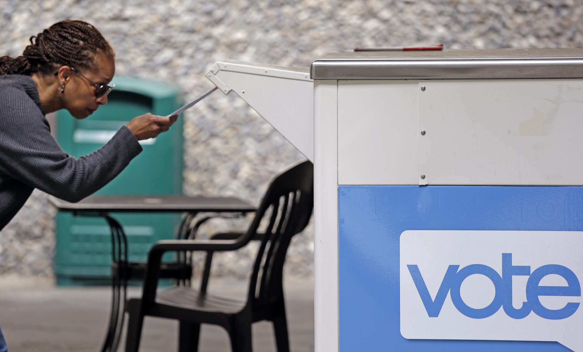 Eudora Carter carefully drops her ballot into a drop-off voting box Tuesday in Seattle. (AP Photo/Elaine Thompson)