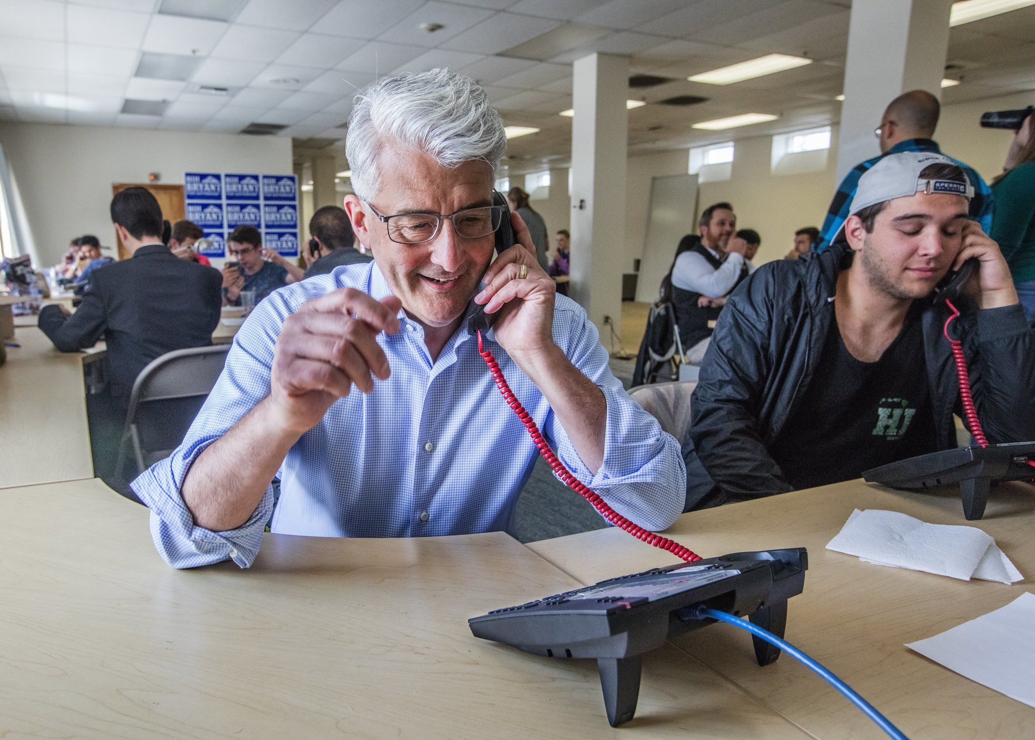 Bill Bryant, Republican candidate for Washington governor, phones potential voters and requests they submit their primary ballots Tuesday at his campaign headquarters in Seattle’s Sodo neighborhood. (Steve Ringman/The Seattle Times via AP)