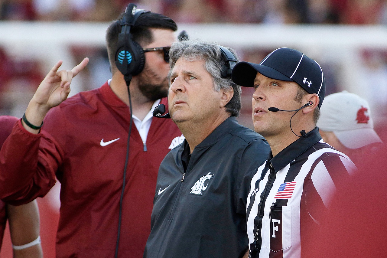 Washington State head coach Mike Leach, center, watches a replay during the first half of an NCAA college football game against the Eastern Washington in Pullman, Wash., Saturday, Sept. 3, 2016. (AP Photo/Young Kwak)