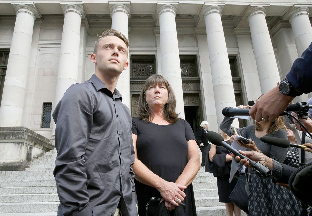 Stephanie McCleary and her son Carter McCleary, 17, talk to reporters Wednesday in Olympia following a state Supreme Court hearing on the ongoing battle surrounding the state’s constitutional requirement to properly fund basic education. Stephanie McCleary, of Chimacum is one of the plaintiffs in the case. (Ted S. Warren/The Associated Press)