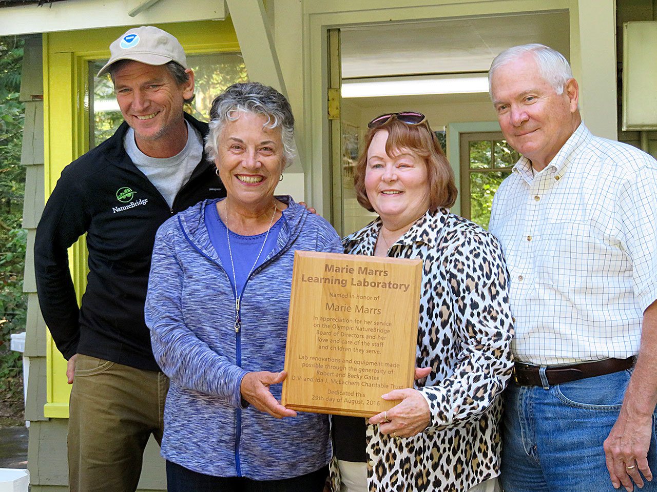 Marie Marrs, second from left, accepts a plaque naming the new science learning laboratory at NatureBridge in Olympic National Park in her honor. The presentation was made by Stephen Streufert, left, and Becky and Robert Gates, right, at the NatureBridge campus at Lake Crescent.