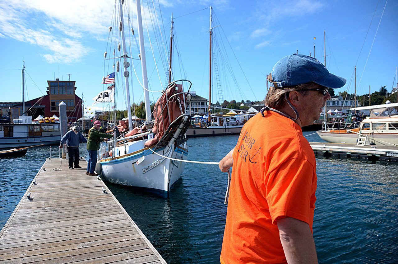 Marina crew members help dock a sail boat in the Point Hudson Marina in Port Townsend. The marina will be packed with boats of all shapes and sizes this weekend for the Wooden Boat Festival. (Cydney McFarland/Peninsula Daily News)