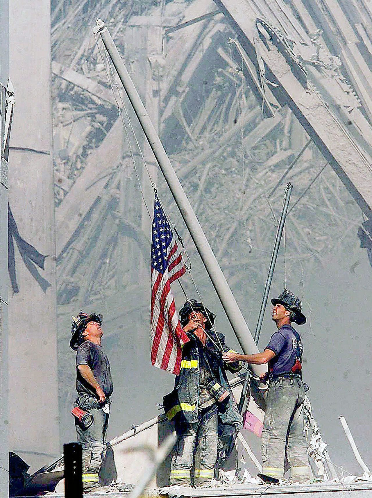 Brooklyn firefighters raise a flag at the site of the World Trade Center in New York on Sept. 11, 2001. The flag turned up in 2014 in Everett under mysterious circumstances. (Thomas E. Franklin/The Record of Bergen County, N.J., via AP)