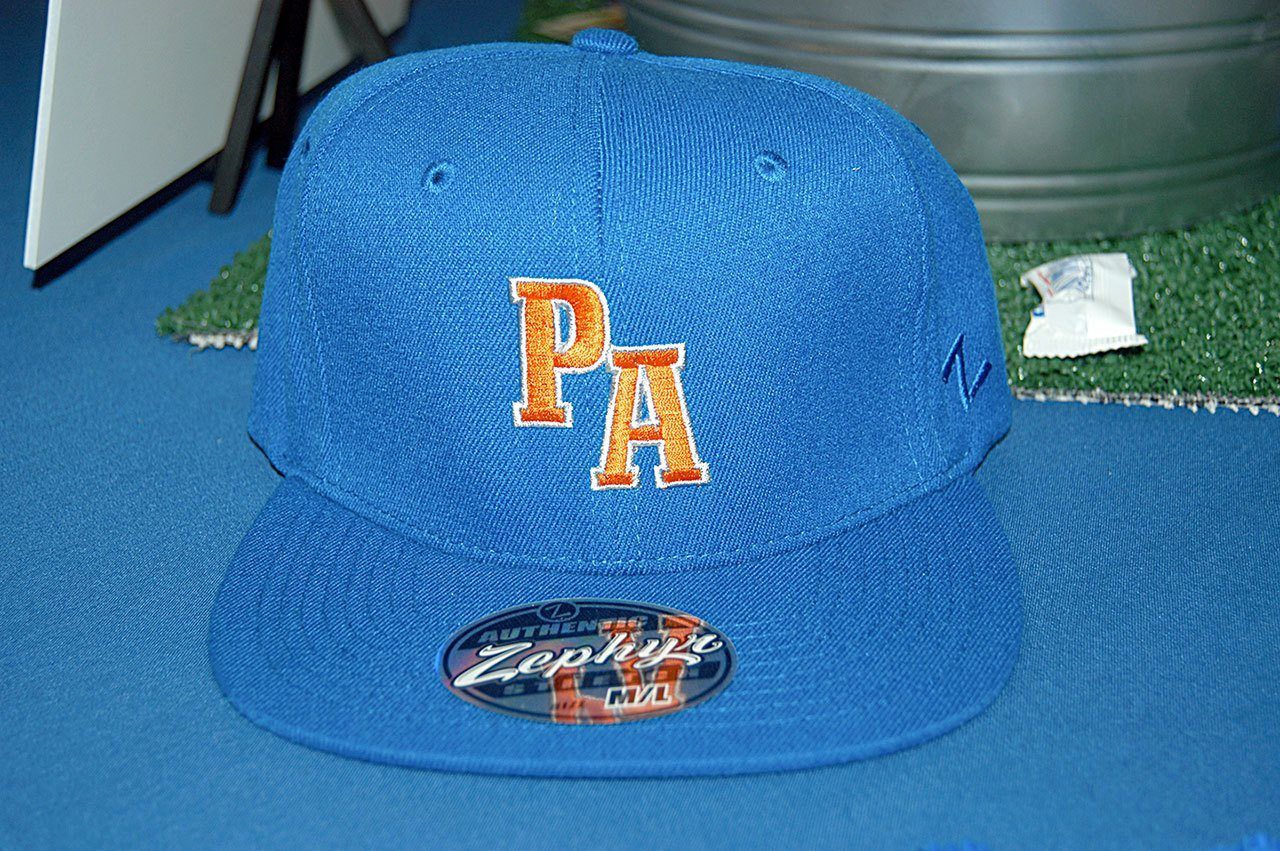 The new Port Angeles Lefties caps will feature orange PA lettering on a sky-blue background. (Rob Ollikainen/Peninsula Daily News)