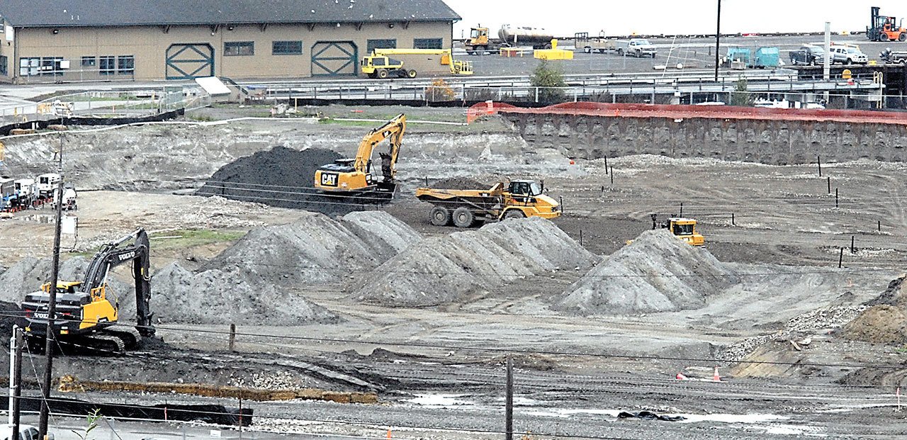 Excavators and bulldozers remove dirt at the site of the former KPly mill in Port Angeles earlier this year. (Keith Thorpe/Peninsula Daily News)