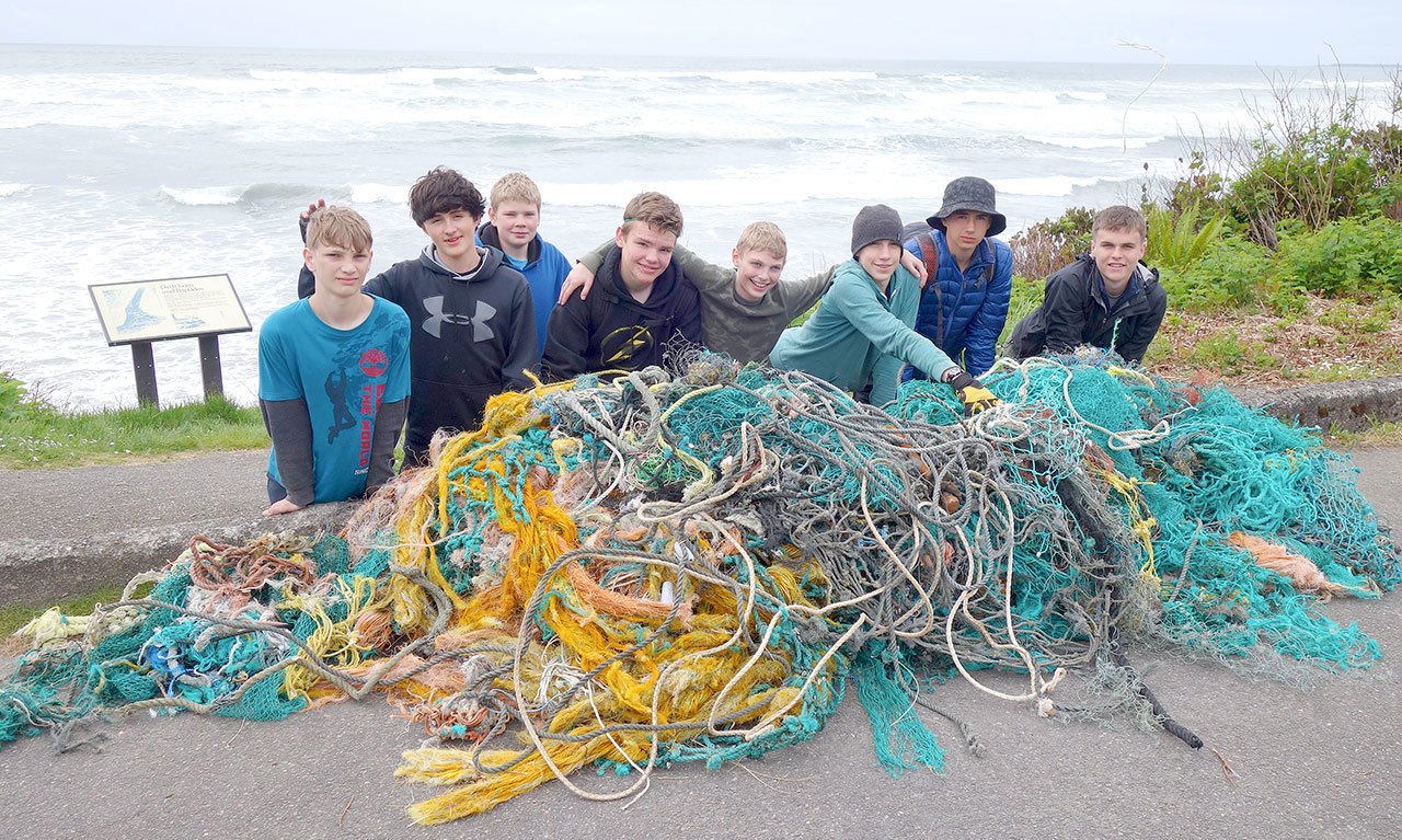 Boy Scout Troop 1498 of Sequim gathers around a collection of rope and nets they picked up during a previous beach clean up day near Kalaloch. (Peter Craig)