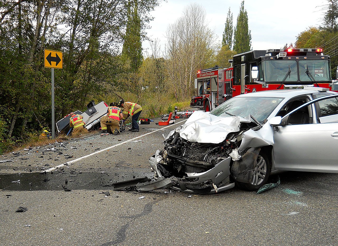 Medic units from Port Ludlow Fire & Rescue and East Jefferson Fire-Rescue respond to a two-vehicle accident at the intersection of state Highway 19 and Oak Bay Road on Friday. (Port Ludlow Fire & Rescue)