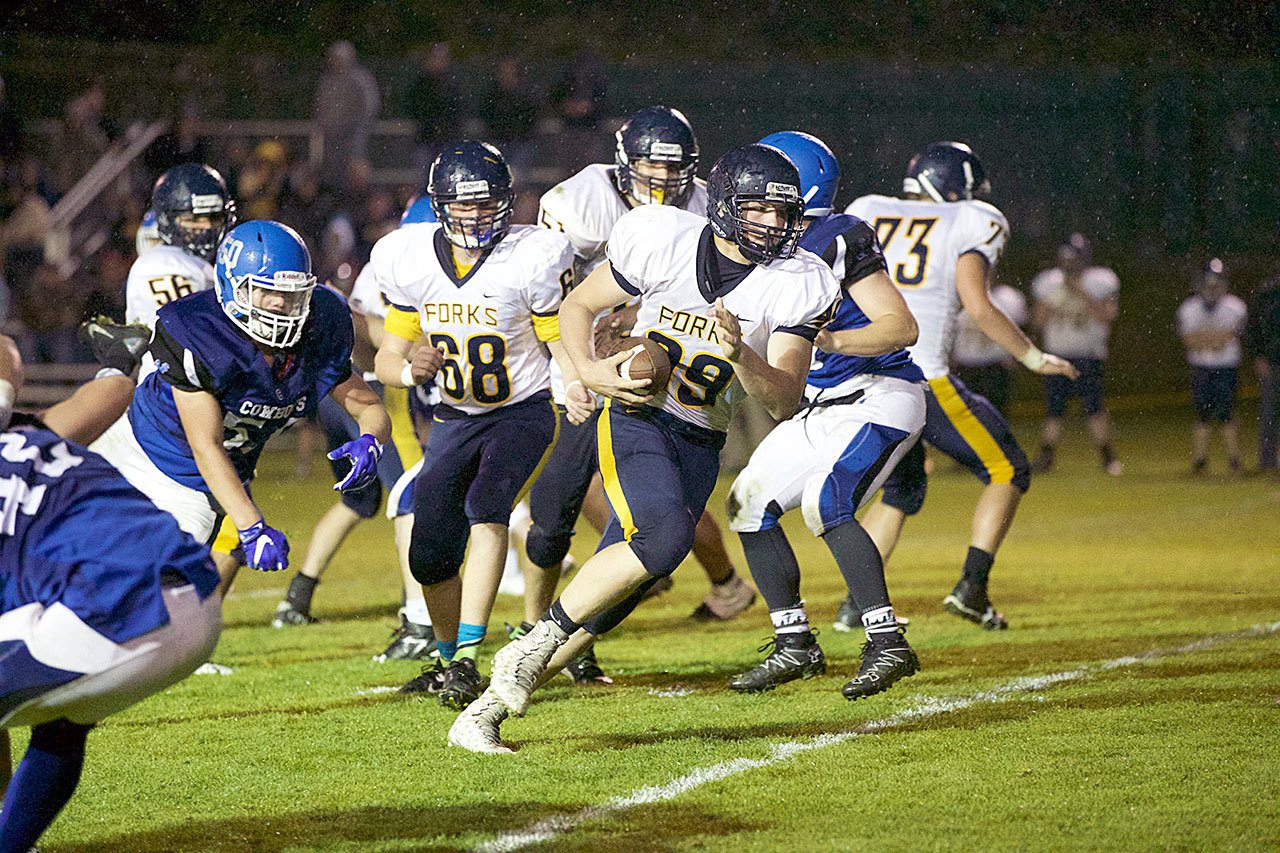 Steve Mullensky/for Peninsula Daily News                                Forks’ Jack Dahlgren (99) runs for a 30-yard gain in the Spartans 48-7 win over Chimacum last Friday in Port Townsend.