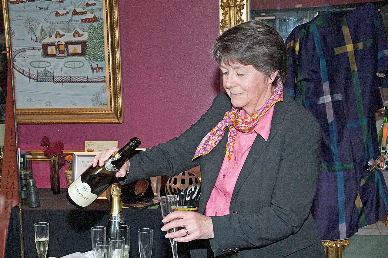 First Step Family Support Center Board President Kathy Murphy-Carey pours a glass of wine during a past Midnight in Paris Dinner and Live Auction. This year’s auction will be from 5:30 p.m. to 9 p.m. Saturday in the ballroom at Red Lion Hotel, 221 N. Lincoln St. (Iantha Frazer)
