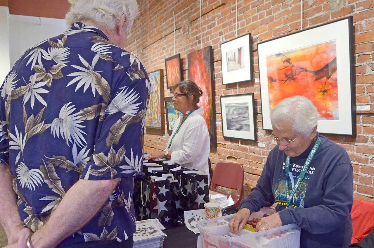 Film Festival volunteer Karen Putterman, right, of Port Townsend checks in volunteers on Thursday in preparation for the weekend’s festivities. (Cydney McFarland/Peninsula Daily News)
