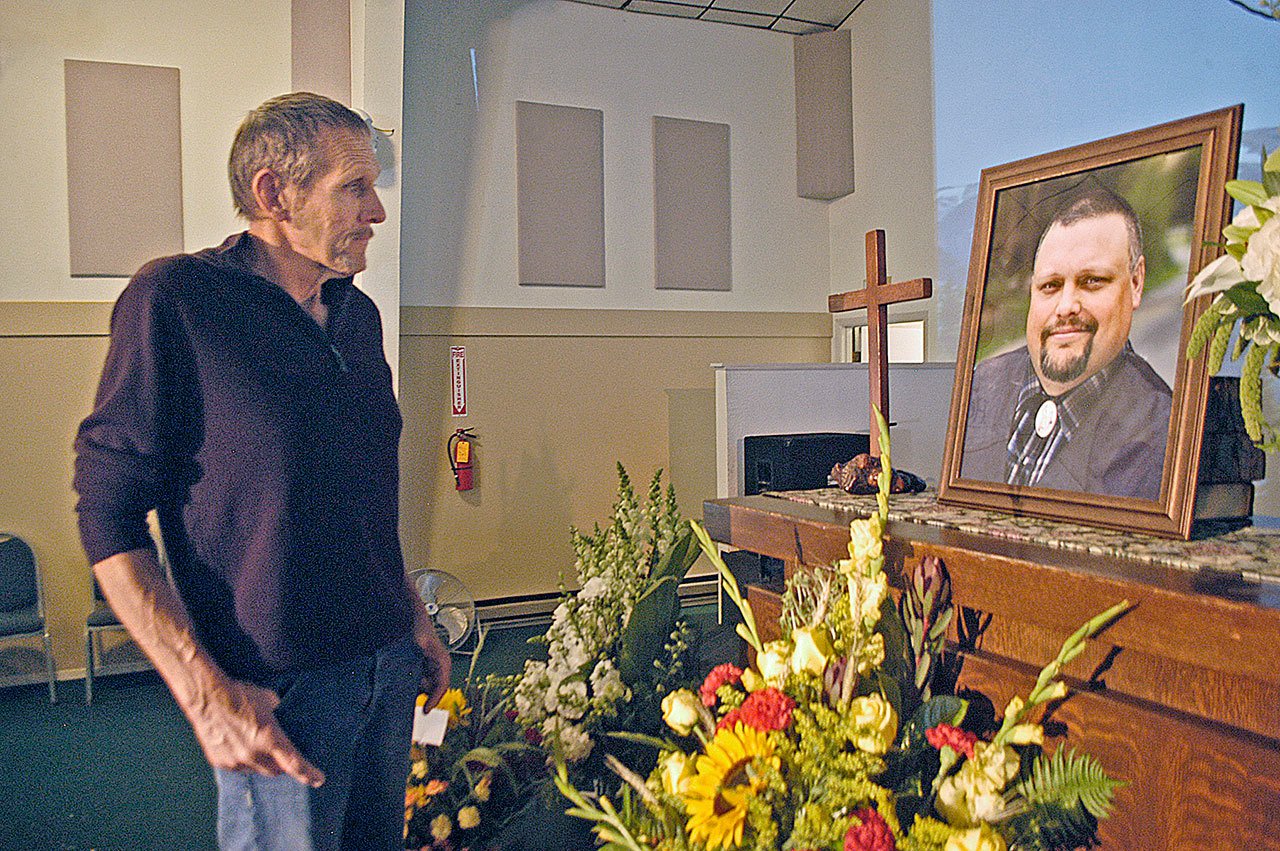 Craig Rygaard, left, father of Gabe Rygaard, pictured at right — a reality TV star and former Clallam County commissioner candidate killed Sept. 16 in a three-vehicle collision — reflects on his son’s life Saturday afternoon following a memorial service at King’s Way Foursquare Church near Carlsborg. (Chris McDaniel/Peninsula Daily News)