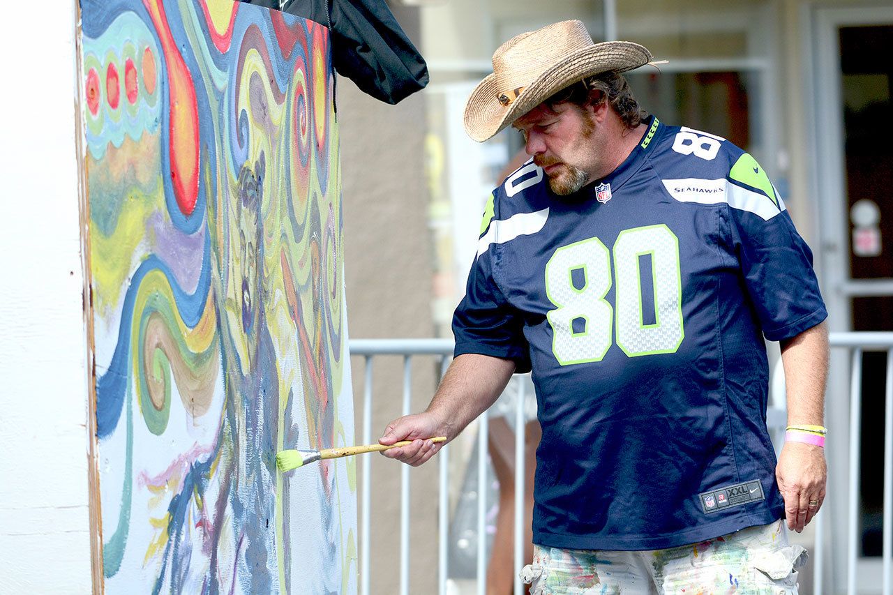Jeff Tocher of Port Angeles live paints during Arts and Draughts in downtown Port Angeles on Sunday. (Jesse Major/Peninsula Daily News)