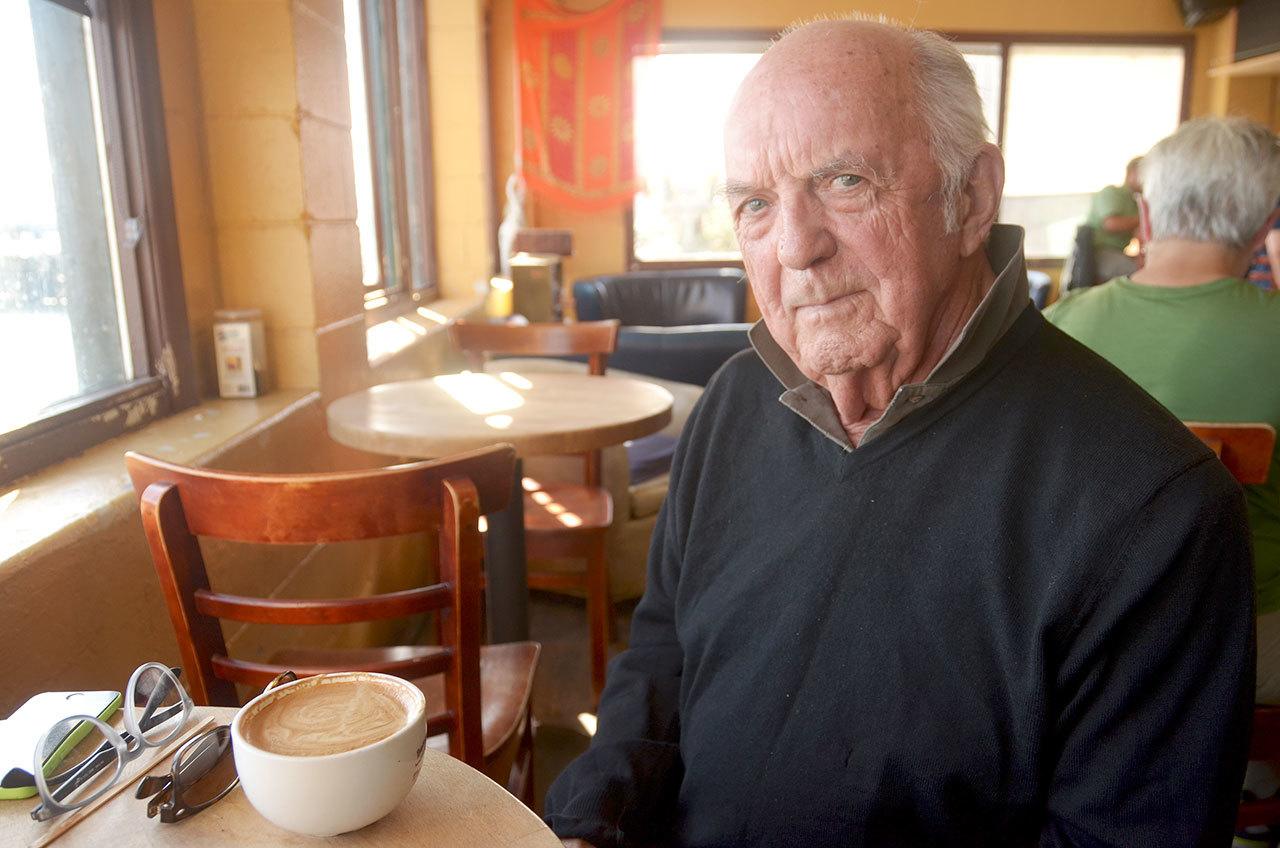 Ron Colby, whose documentary “By Us” was shot in and is about the small communities in and around Port Townsend, grabs a cup of coffee at Better Living Through Coffee before heading to catch another film at the Port Townsend Film Festival on Sunday. (Cydney McFarland/Peninsula Daily News)