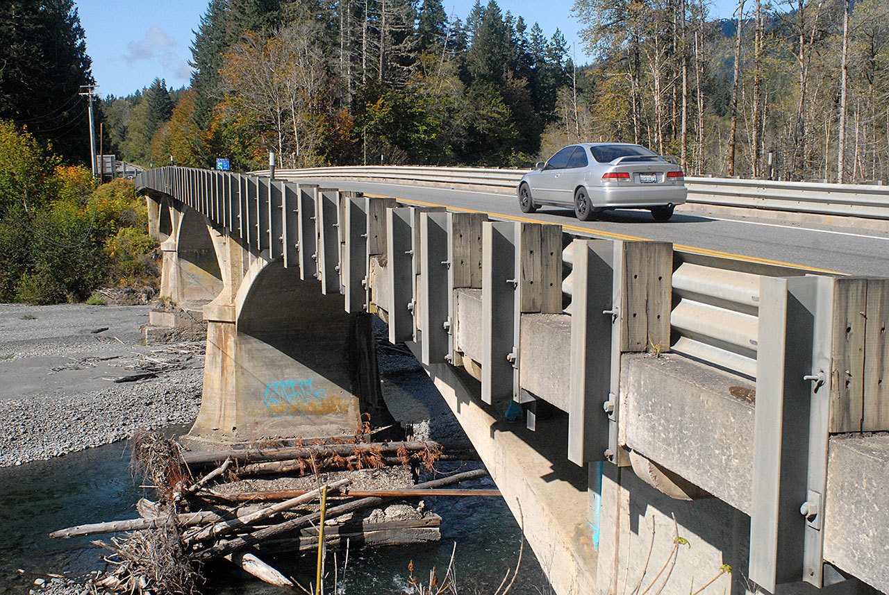 A car crosses the U.S. Highway 101 bridge over the Elwha River southwest of Port Angeles on Tuesday. Motorists can expect delays at the bridge starting today as inspectors examine the bridge footings. (Keith Thorpe/Peninsula Daily News)