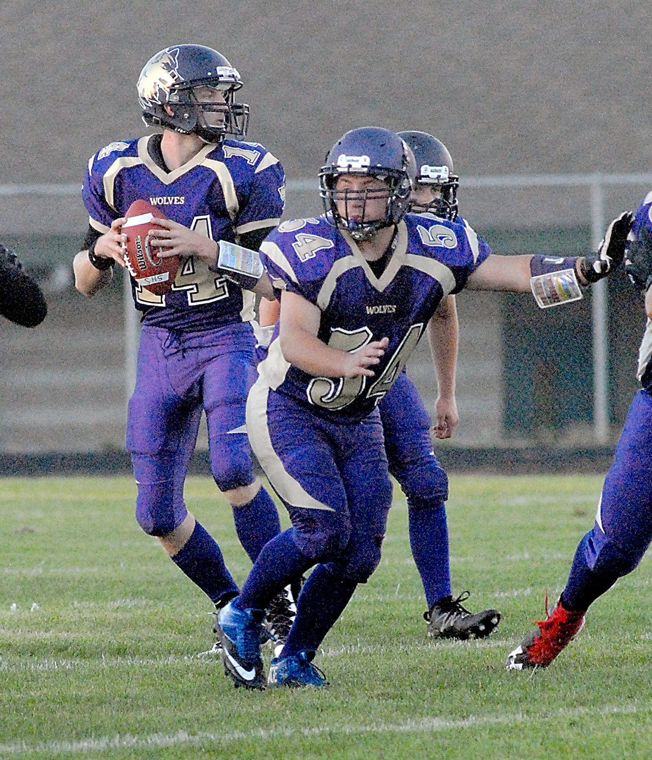 Keith Thorpe/Peninsula Daily News Sequim quarterback Riley Cowen, left, drops back to pass with protection from teammates Adam DiFilippo, center, and Hayden Gresli during the Wolves 66-34 loss to Montesano earlier this month.