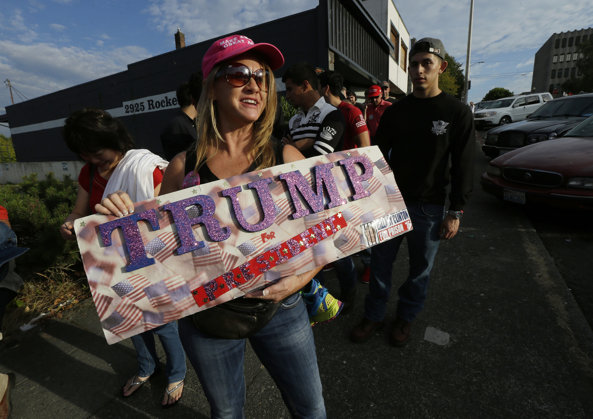 Marcyann Ritchie, of Snohomish holds her homemade sign supporting Republican presidential candidate Donald Trump as she waits in line Tuesday for a Trump rally in Everett. (Ted S. Warren/The Associated Press)
