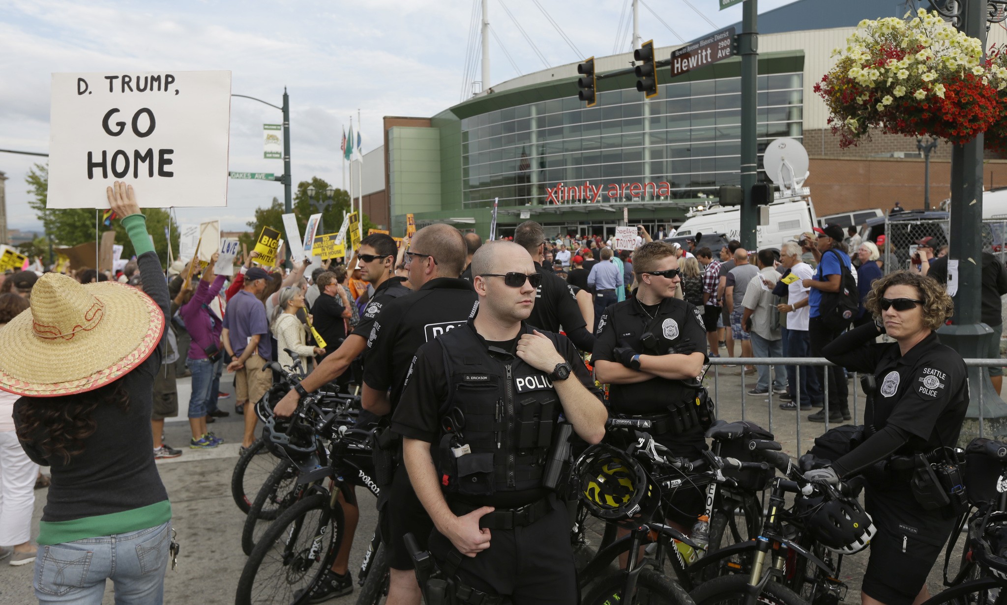 Seattle police officers stand watch near protesters outside a rally for Republican presidential candidate Donald Trump in Everett. (Ted S. Warren/The Associated Press)