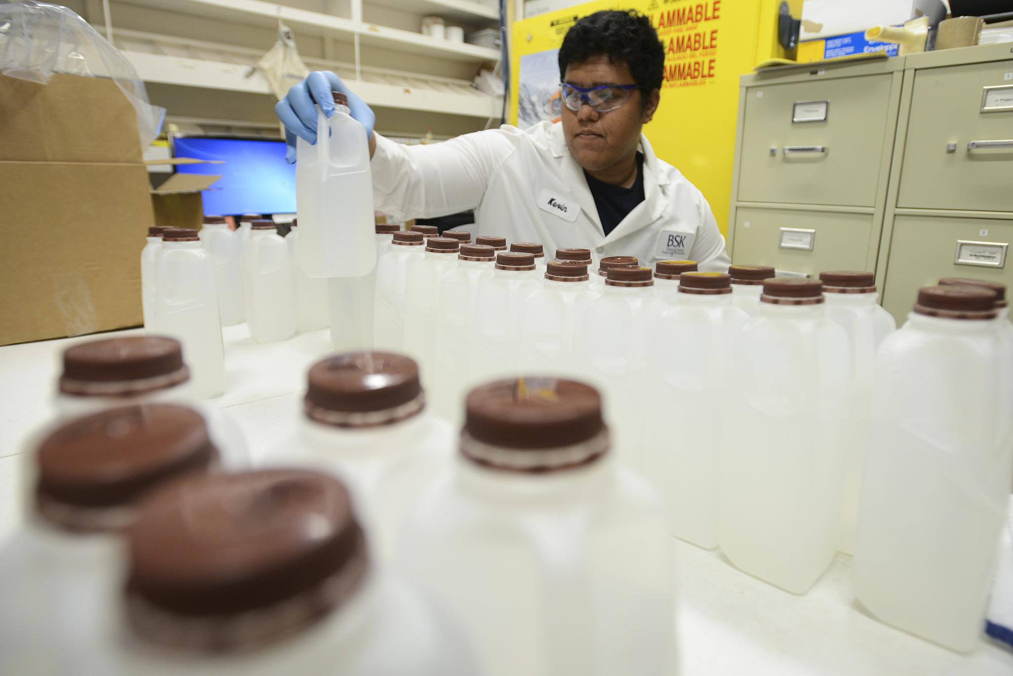 In an Aug. 31, 2016 photo,                                Kevin Churo, a lab assistant at BSK Labs in Vancouver, organizes samples of water last month in a temporary work space set up to deal with an increase in tests sent to the lab due to recent headlines about elevated levels of lead in drinking water at schools. (Ariane Kunze/The Columbian via AP)