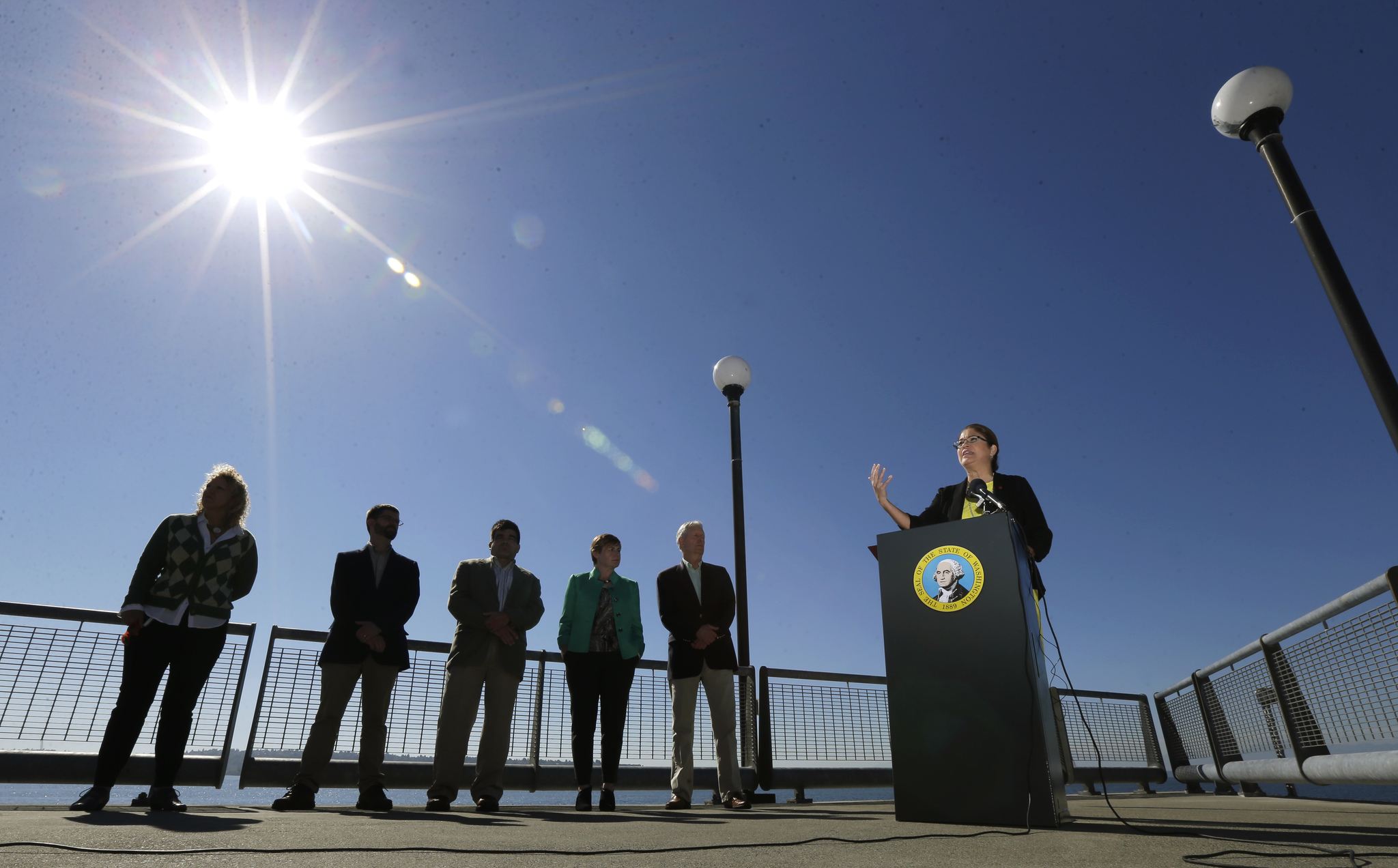 Maia Bellon, right, director of the state Department of Ecology, speaks at a news conference Thursday overlooking Elliott Bay in Seattle. (Ted S. Warren/The Associated Press)