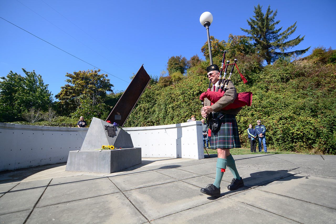Rick McKenzie, a retired Coast Guard veteran, plays bagpipes at the 9/11 memorial at the Francis Street Park in Port Angeles on Sunday. (Jesse Major/Peninsula Daily News)