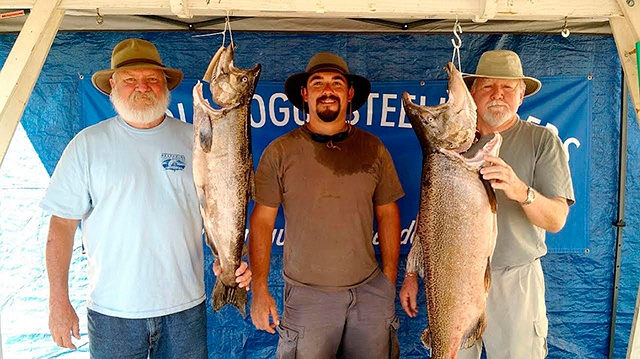 Mark Thompson, right, of Port Angeles, poses with the winning 32.4-pound king caught during the Restoring the Rogue Salmon Derby held last month on the Rogue River near Grants Pass, Ore. At far left is Thompson’s teammate, high school classmate and fellow Marine, Carl Cole and guide Matt Judkins.