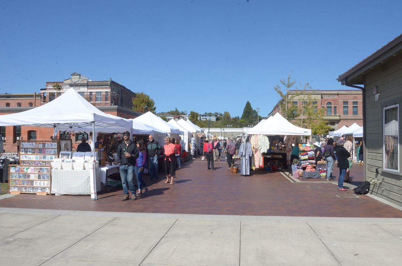 Sunday’s sunny and calm conditions brought plenty of people out to the Crafts by the Dock fundraiser for the Port Townsend Arts Guild. (Cydney McFarland/Peninsula Daily News)
