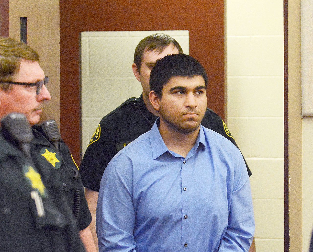 Arcan Cetin is escorted into Skagit County District Court by Skagit County’s sheriff’s deputies Monday. Cetin is being held under a magistrate’s warrant, which will give Skagit County prosecutors 30 days to file charges in relation to the Cascade Mall shooting that took place Friday evening. Five people were killed in the shooting, and Cetin is being held on a $2 million bail. (Brandy Shreve/Skagit Valley Herald via AP)