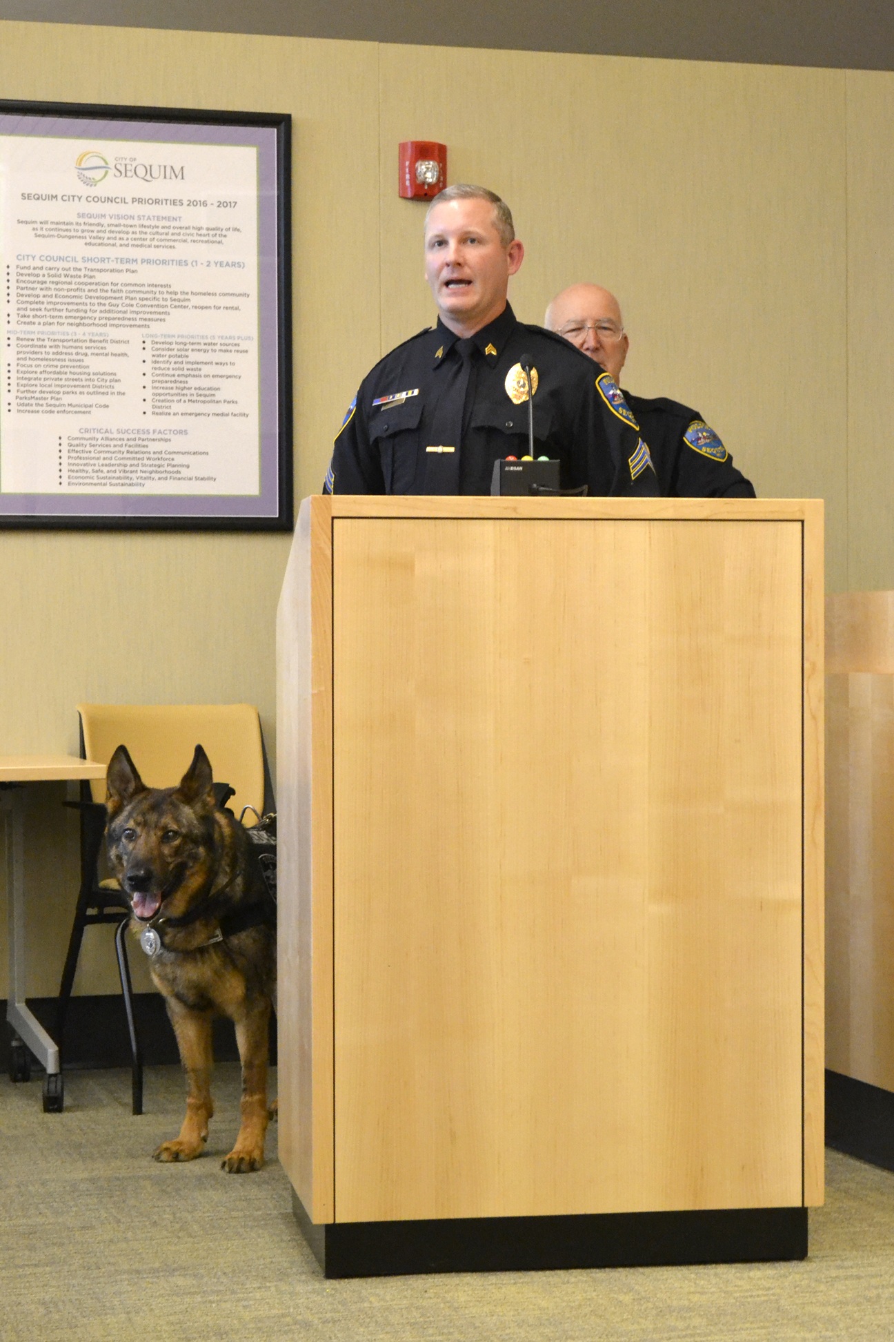 Sgt. Mike Hill speaks about his former partner Chase the K-9 officer, who officially retired Monday after being with the Sequim Police Department since 2008. Police Chief Bill Dickinson said he plans to continue the K-9 officer program in the coming months after they find a replacement dog and begin training new K-9 officer Tony Bush. (Matthew Nash/Olympic Peninsula News Group)