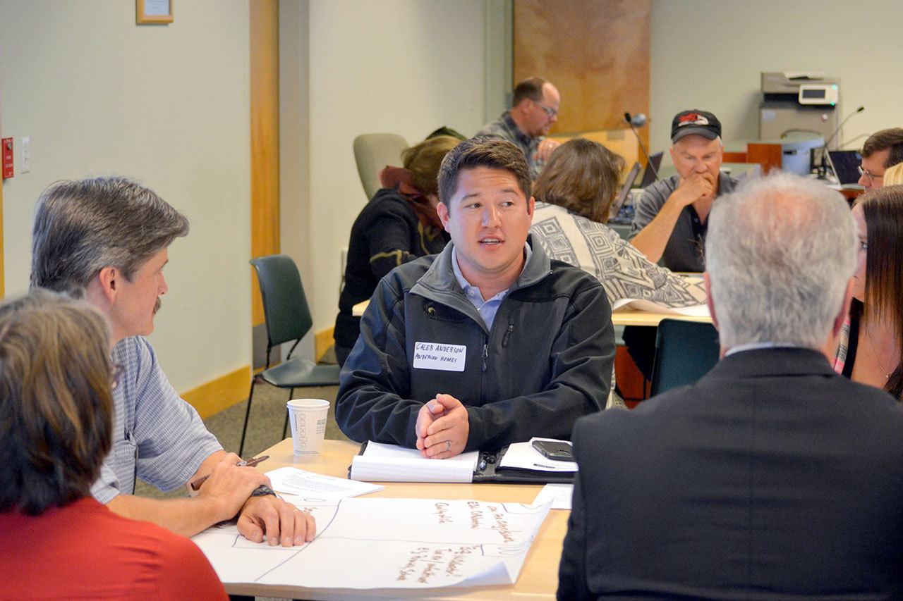 Caleb Anderson of Anderson Homes talks with his group about economic development strengths and weaknesses in the area Monday at the Clallam Transit Center. (Matthew Nash/Olympic Peninsula News Group)