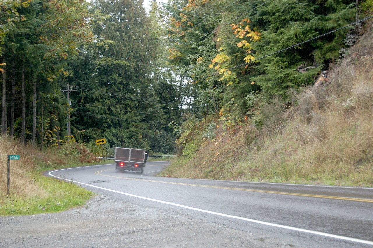 A truck heads into a corner on Black Diamond Road on Monday. Clallam County will widen and straighten the road south of Port Angeles next year. (Rob Ollikainen/Peninsula Daily News)